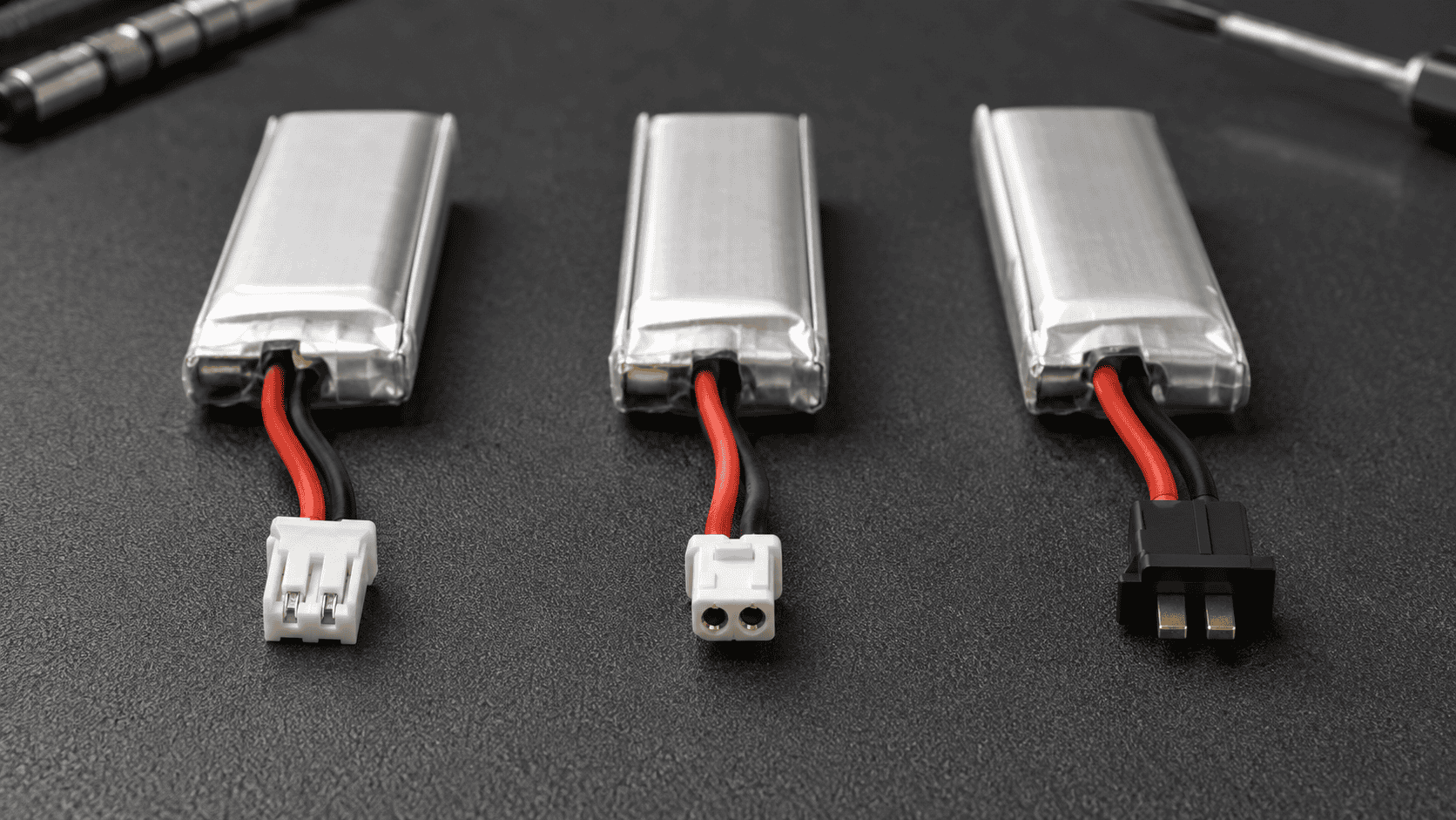 PH2.0, BT2.0 and A30 connectors beside three 1S tiny-whoop batteries.