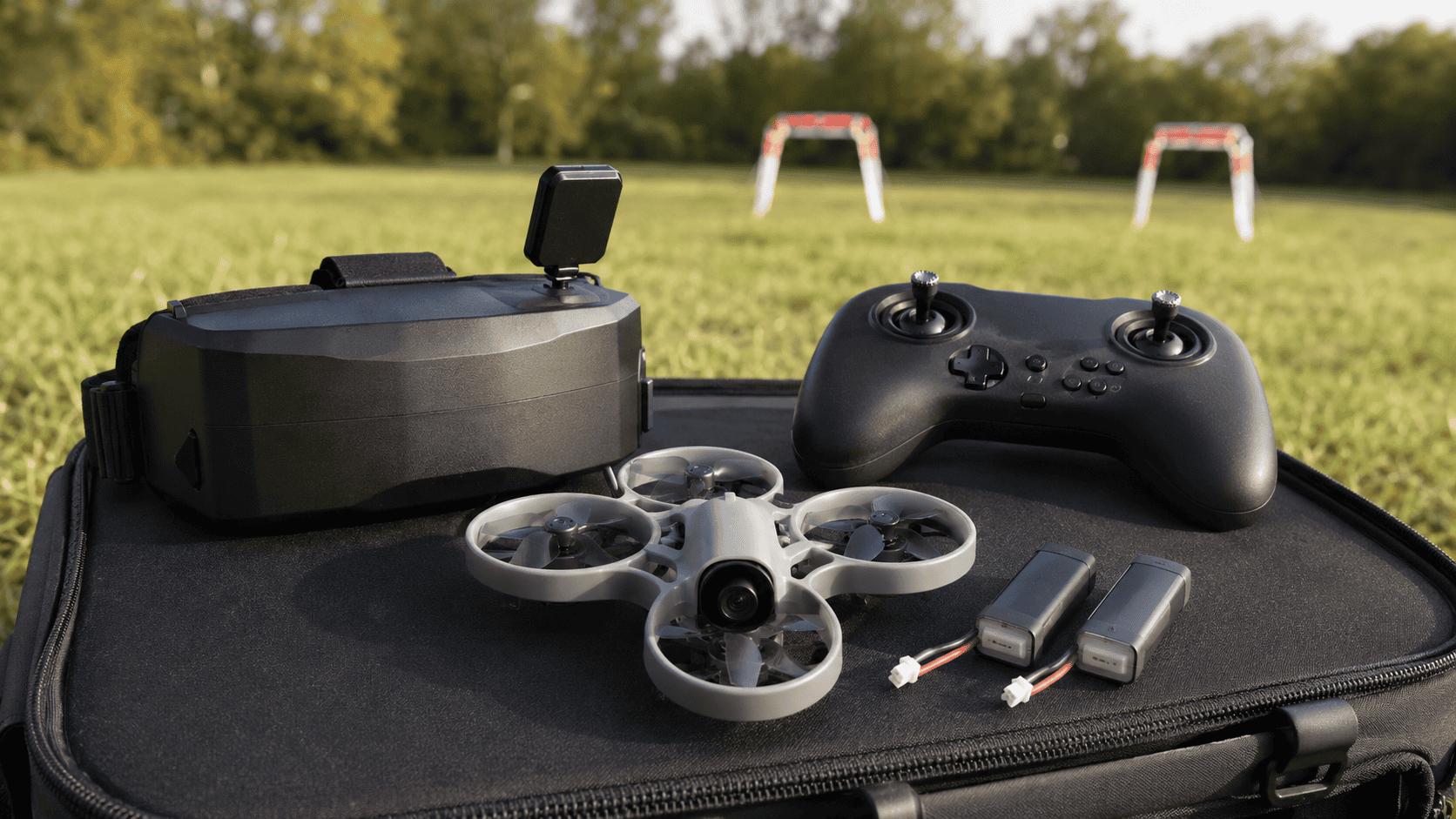 Illustrated protected FPV training drone beside box goggles and a compact radio on a backyard practice course.