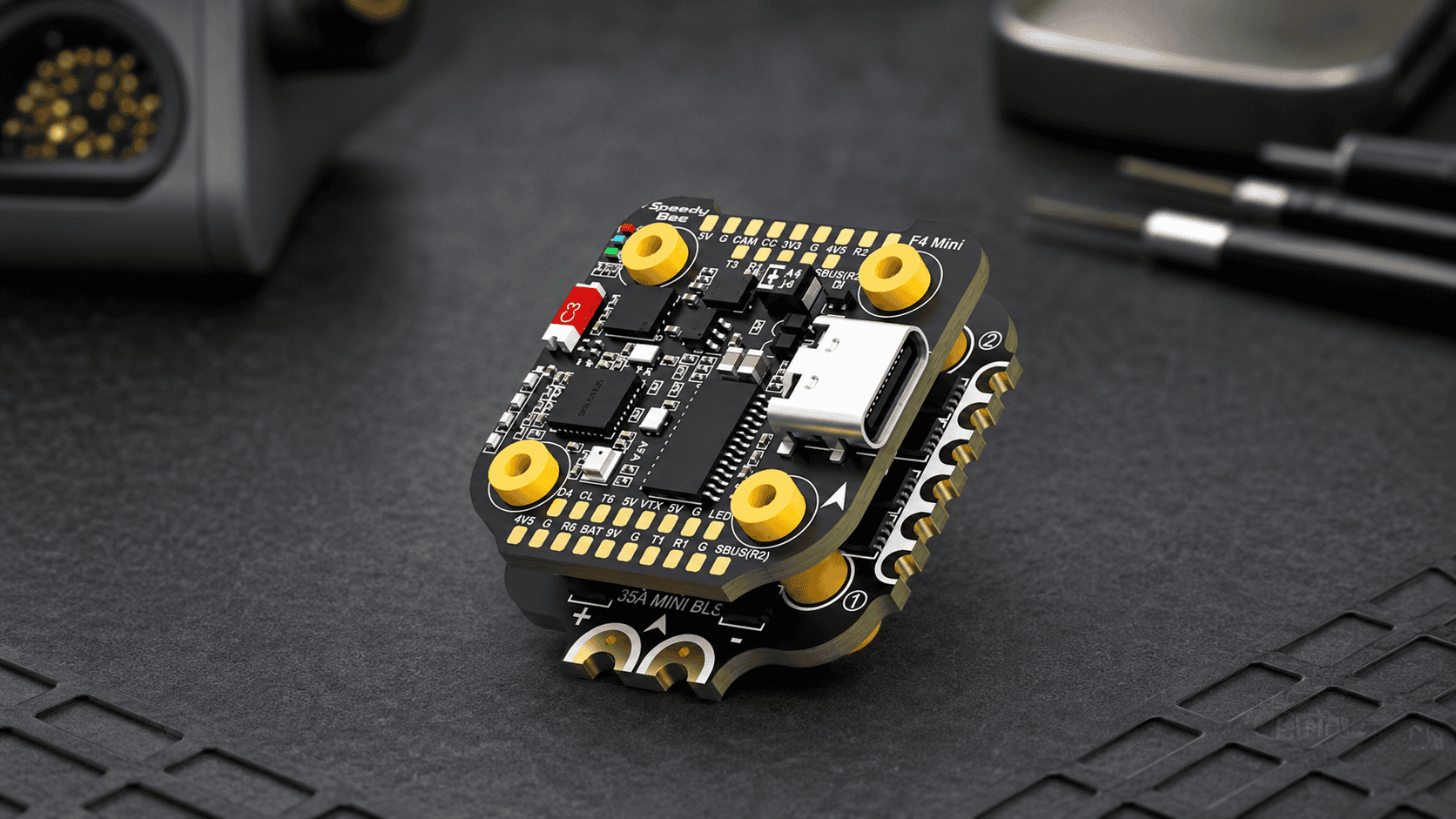 SpeedyBee F405 Mini flight controller and BLS 35A ESC on an electronics workbench