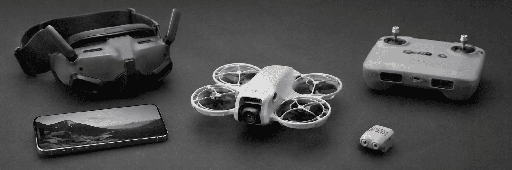DJI Neo 2 beside a smartphone, Digital Transceiver, remote controller, and compatible goggles.