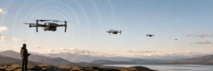Compact camera drone flying away from an observer as its sound waves fade with distance.