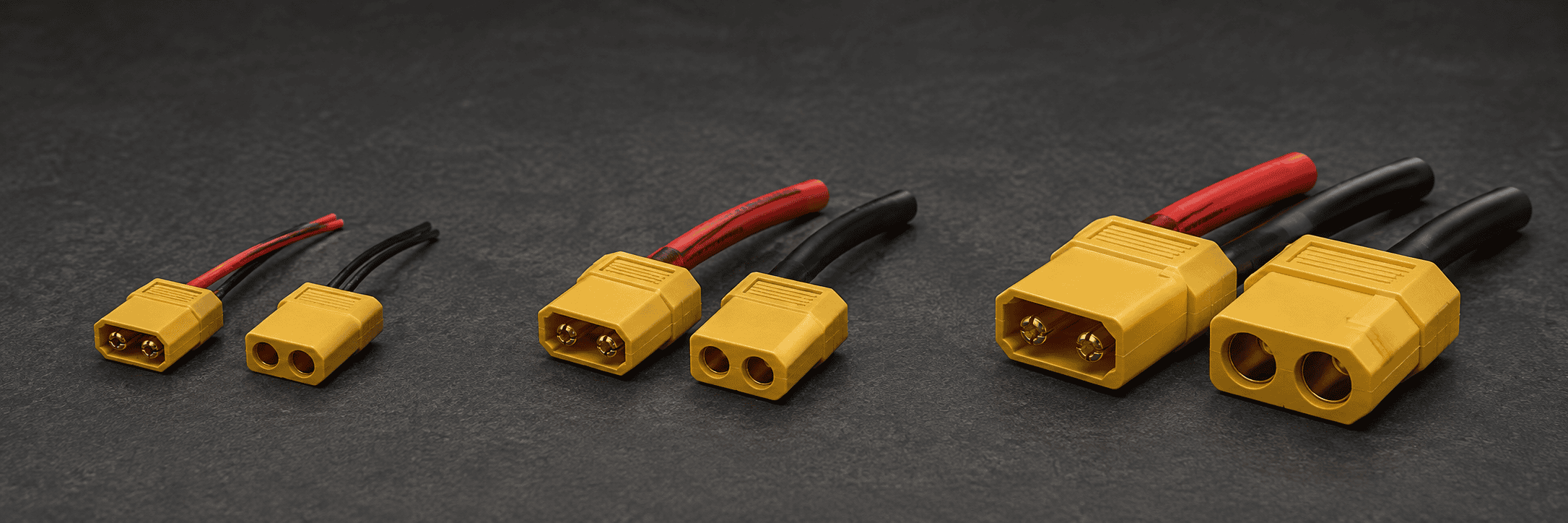 Three unbranded yellow RC connector pairs progressing from XT30 to XT90 size with progressively thicker red and black leads